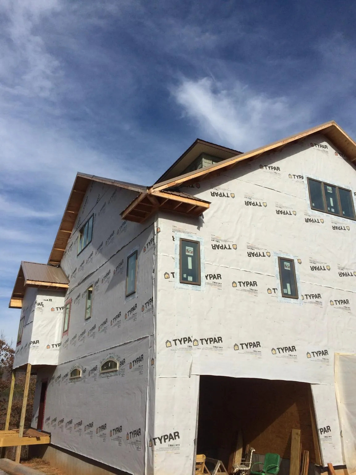 Stick built house wrapped in Typar with new roof framing and dormers in Pell Lake